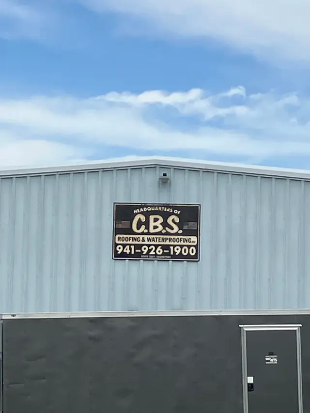 Sign at the CBS Roofing and Waterproofing headquarters in Sarasota reading Headquarters of C.B.S. Roofing and Waterproofing Inc, 941-926-1900